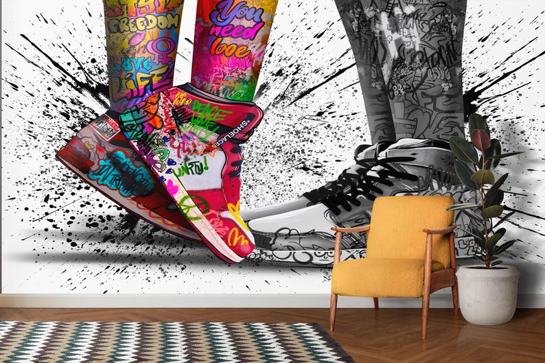 May include: A pair of sneakers with colorful graffiti designs, including the words "freedom", "you need love", and "unify". The sneakers are set against a black and white splatter paint background.