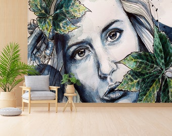May include: A watercolor painting of a woman's face with green leaves covering part of her face. The woman's eyes are open and she is looking directly at the viewer. The painting is done in shades of blue and green.