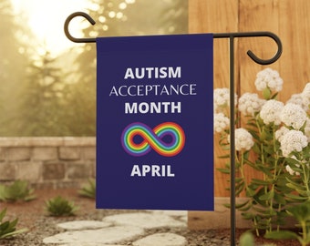 May include: A rectangular dark blue garden flag featuring the white text AUTISM ACCEPTANCE MONTH and APRIL, with a multicolored rainbow infinity symbol centered between the text, hanging from a black metal garden flag stand.
