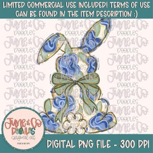 May include: A digital illustration of a blue and gold bunny with a green bow. The bunny is sitting on a white cloud with a floral pattern. The image is 300 DPI.