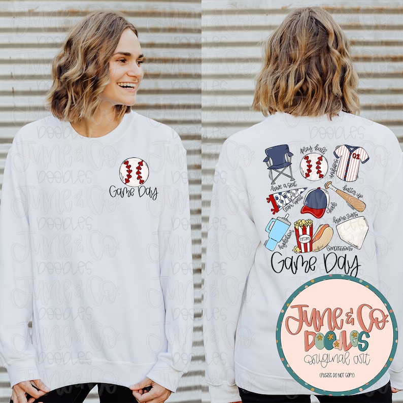 May include: White sweatshirt with a baseball graphic and the text "Game Day" on the front. The back of the sweatshirt features a baseball-themed design with a baseball, bat, glove, hat, cooler, hot dog, popcorn, and a folding chair. The text "Game Day" is also on the back of the sweatshirt.