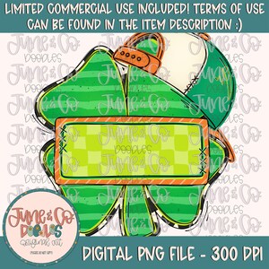 May include: A green four-leaf clover with a white and green striped pattern. A white baseball cap with orange stitching and a checkered banner are on top of the clover. The banner has the text "June & Co. Doobles" in orange.