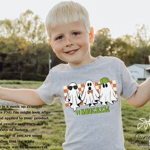 May include: A gray t-shirt with a graphic of three ghosts wearing sunglasses, a bow tie, and a green hat. The text '#BOOCREW' is below the ghosts.