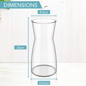 May include: A clear glass vase with a wide base and a narrow neck. The vase is 8.5 inches tall, 10.5 inches wide at the base, and 20 inches tall.