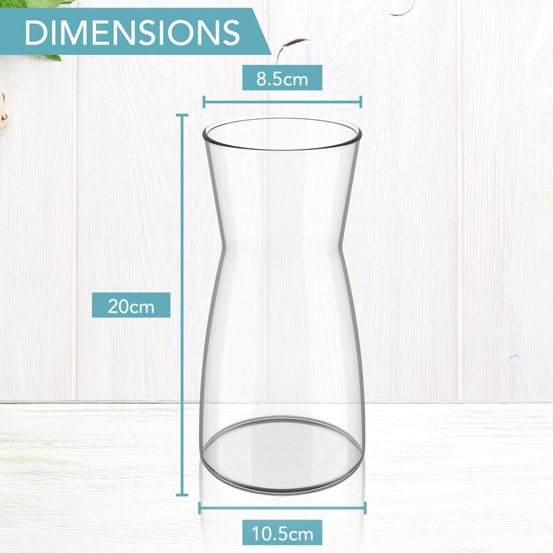 May include: A clear glass vase with a wide base and a narrow neck. The vase is 8.5 inches tall, 10.5 inches wide at the base, and 20 inches tall.