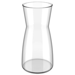 May include: A clear glass pitcher with a wide base and a narrow neck. The pitcher is empty and has a smooth, polished surface.