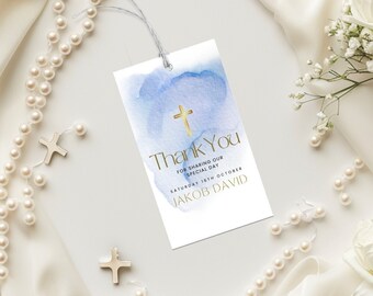 以下が含まれることがあります： 青い水彩のサンキュータグ。金の十字架と「Thank You for sharing our special day Saturday 18th October Jakob David」の文字が書かれています。