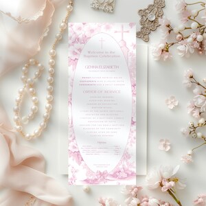 May include: A pink and white baptism program with floral designs. The program includes the name "Gemma Elizabeth" and the order of service for the ceremony.