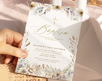 May include: Baptism invitation card with floral watercolor design. The card features gold text and a cross, with details including the date, time, and location of the event. The invitation is held in a hand.