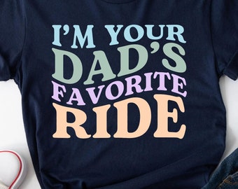 May include: A navy blue t-shirt with the text "I'm your Dad's Favorite Ride" in colorful letters.