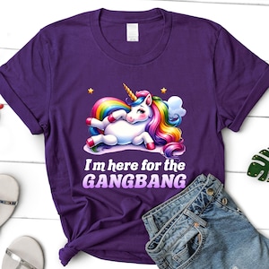 K&ouml;nnte beinhalten: Lilafarbenes T-Shirt mit einem Regenbogen-Einhorn-Motiv und dem Text "I'm here for the GANGBANG".