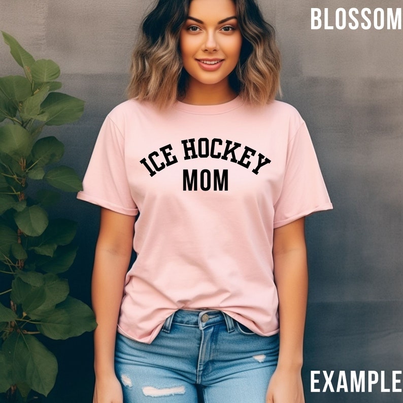 May include: A pink t-shirt with the text "ICE HOCKEY MOM" in black lettering.