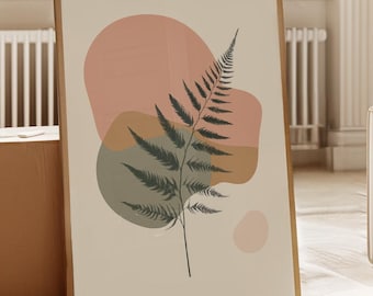 May include: A framed art print featuring a fern illustration with abstract shapes in muted pink, green, and brown tones. The artwork is displayed in a bright, airy room with natural light, a large window, and a wooden floor.