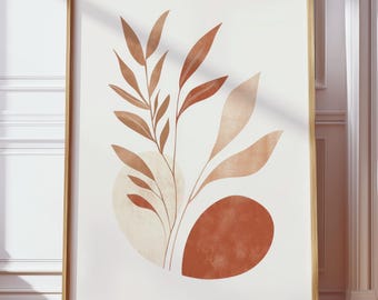 Op de afbeelding: Een ingelijste kunstdruk met een abstract botanisch ontwerp. Het kunstwerk toont gestileerde bladeren en organische vormen in bruin- en beigetinten tegen een witte achtergrond. De print is ingekaderd in een goudkleurige houten lijst, wat een vleugje elegantie toevoegt.