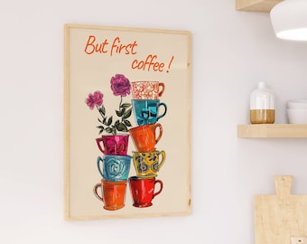 May include: A framed print featuring a stack of colourful coffee cups and a floral arrangement. The text "But first coffee!" is printed in orange on the print.