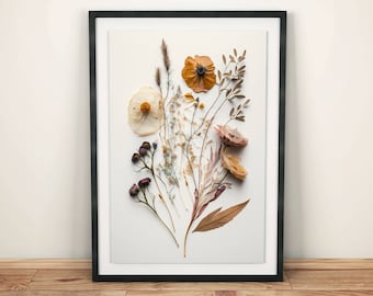 May include: A framed print of pressed flowers in shades of brown, white, and yellow. The flowers are arranged in a bouquet-like shape and are set against a white background.