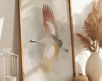 May include: A framed art print featuring a crane in flight, with a color palette of muted earth tones. The artwork is displayed on a wooden cabinet, alongside a vase of dried pampas grass, a small decorative jar, a glass bottle, and a white candle.