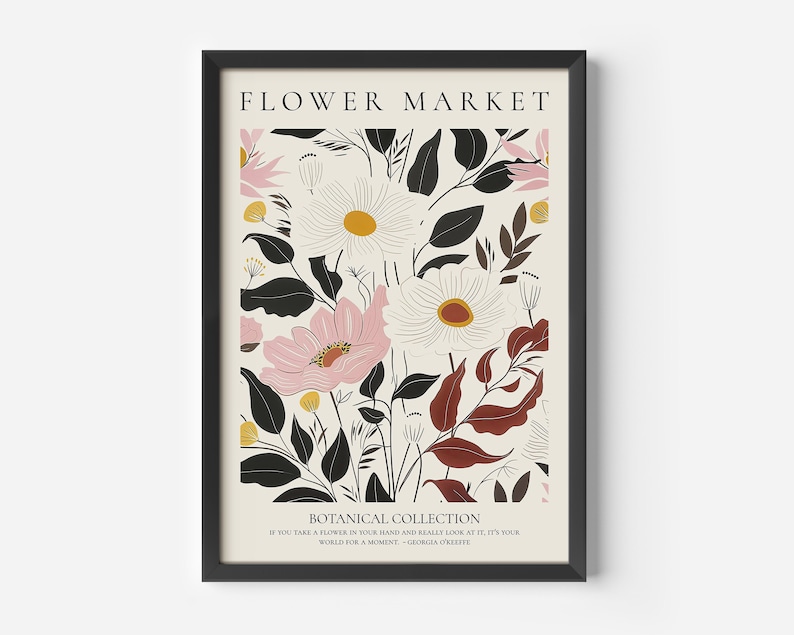 May include: A framed print with a floral design featuring pink, white, and black flowers with brown leaves. The print has the text "FLOWER MARKET" and "BOTANICAL COLLECTION" at the top and bottom. The text at the bottom also includes a quote: "If you take a flower in your hand and really look at it, it's your world for a moment." - Georgia O'Keeffe