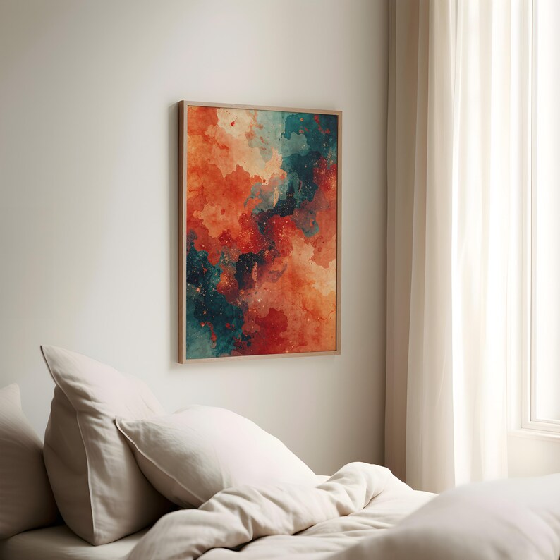 May include: Abstract art print in a wooden frame. The artwork features a watercolor design with a blend of orange, teal, and red hues. The painting has a dreamy, cloud-like appearance, with small white speckles throughout.