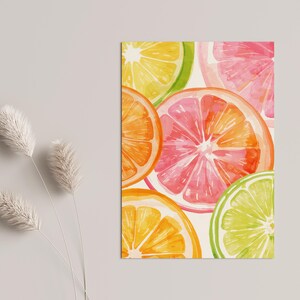 May include: Watercolor illustration of citrus fruit slices, including orange, grapefruit, lime, and lemon. The vibrant artwork features a mix of colors, such as pink, yellow, green, and orange. The fruit slices are arranged in a close-up composition.