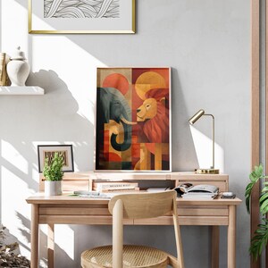 May include: A framed art print featuring an elephant and a lion in a geometric design with orange, red, and brown tones. The artwork is displayed on a wooden desk with a small lamp and a potted plant. The desk is in a room with a wooden accent wall.