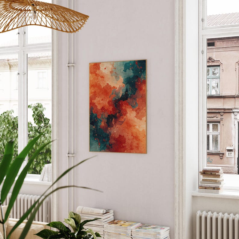 May include: Abstract art print featuring a blend of orange, teal, and dark blue hues. The artwork has a watercolor effect with a gold frame. The painting is displayed on a white wall in a well-lit room.
