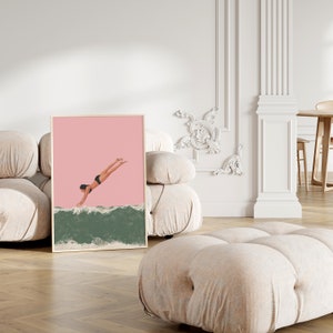 May include: A framed illustration of a person diving into a green wave against a pink background.