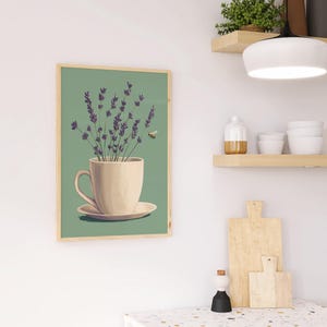 May include: A framed print of a white teacup with lavender flowers and a bee flying above it, on a green background.