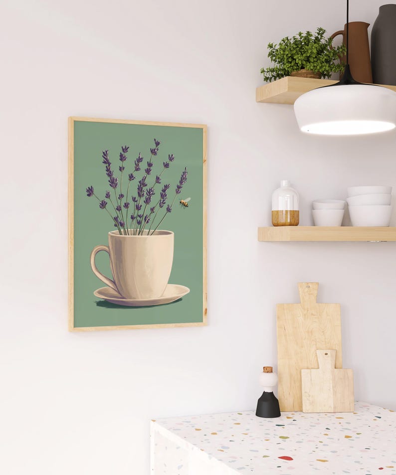 May include: A framed print of a white teacup with lavender flowers and a bee flying above it, on a green background.