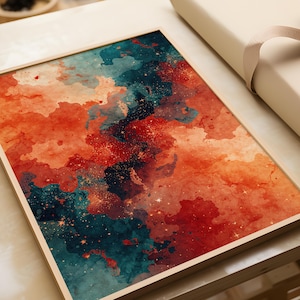 May include: A framed abstract art print featuring a watercolor design. The artwork showcases a blend of orange, teal, and dark blue hues, with speckled gold accents. The print is set within a light-colored wooden frame, creating a modern aesthetic.