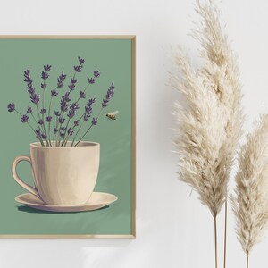 May include: A framed illustration of a white teacup with a saucer, filled with purple lavender flowers and a small bee flying above. The background is a muted green color.