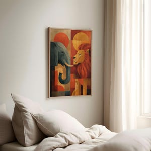 May include: A framed art print featuring a geometric design of an elephant and a lion. The artwork uses a palette of orange, red, and blue, with circular and rectangular shapes. The print is displayed on a white wall.