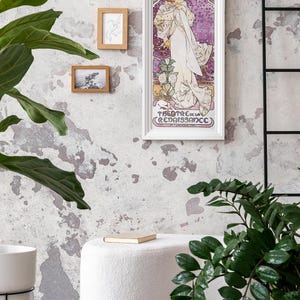 May include: A white framed poster with a vintage illustration of a woman in a white dress with a floral design. The poster is titled "La Dame Aux Camelias" and features the text "Sarah Bernhardt" and "Theatre de la Renaissance".