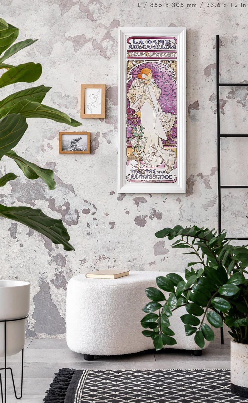 May include: A white framed poster with a vintage illustration of a woman in a white dress with a floral design. The poster is titled "La Dame Aux Camelias" and features the text "Sarah Bernhardt" and "Theatre de la Renaissance".