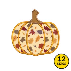 May include: A decorative pumpkin design with a beige background and a pattern of autumn leaves in shades of orange, red, and brown. The pumpkin has a brown stem and gold outlines. The image includes the text "12 sizes" in a yellow circle.