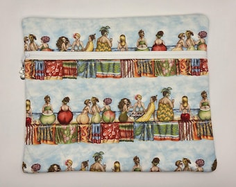 May include: A rectangular quilted fabric pouch featuring a repeating pattern of illustrated figures sitting on colorful beach towels by the ocean. The pouch has a white zipper closure across the top with a small silver charm attached to the zipper pull.