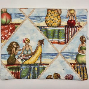 May include: A rectangular quilted fabric pouch featuring a repeating beach scene print with various figures in swimwear, tropical patterns, and fruit-themed designs. The fabric is stitched with a diamond-shaped grid pattern in light beige thread.