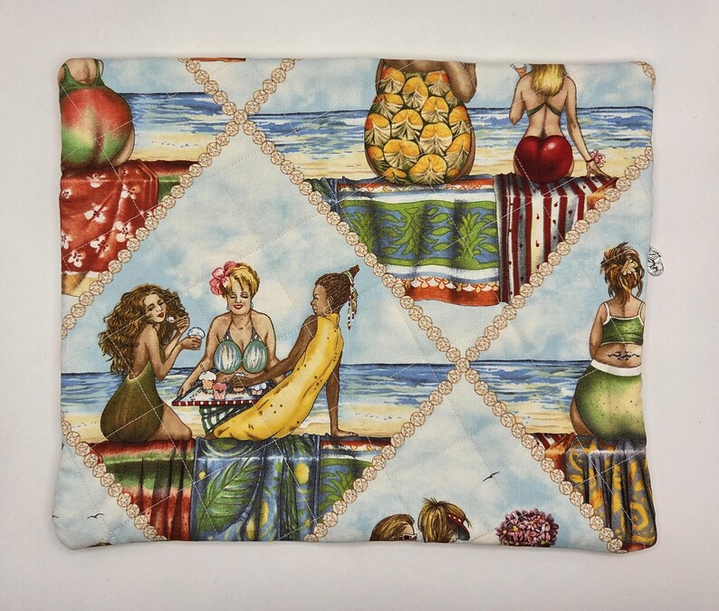 May include: A rectangular quilted fabric pouch featuring a repeating beach scene print with various figures in swimwear, tropical patterns, and fruit-themed designs. The fabric is stitched with a diamond-shaped grid pattern in light beige thread.