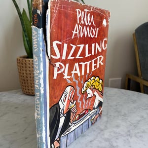 Vintage 1949 first edition hardcover book titled &quot;Peter Arno&#39;s SIZZLING PLATTER&quot; featuring satire cartoons