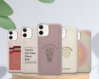 Puede incluir: Cinco fundas de teléfono diferentes con varios diseños. Las fundas son transparentes y muestran el objetivo de la cámara del teléfono. Los diseños incluyen una bombilla con flores, un patrón a cuadros, un degradado de arcoíris y un diseño de texto que dice "You're on your own, kid".