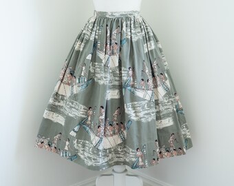 May include: A green full skirt with a print of people in boats. The print is in shades of blue, brown, and white.