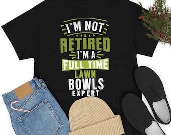 May include: Black t-shirt with a green graphic that says "I'm not retired I'm a full time lawn bowls expert".