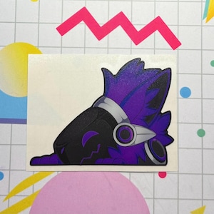 May include: A sticker featuring a stylized, purple and black character with a futuristic helmet and visor. The character is lying down, with its head and upper body visible. The sticker has a white border and is on a colorful background.