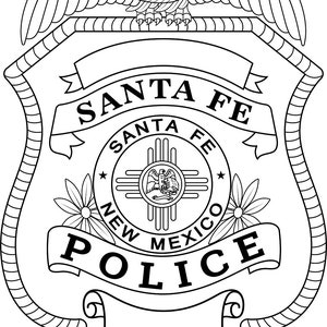 May include: A black and white line drawing of a police badge with the words "Santa Fe Police" and "New Mexico" on it. The badge features a stylised eagle with wings spread and a circle with a symbol of the state of New Mexico.