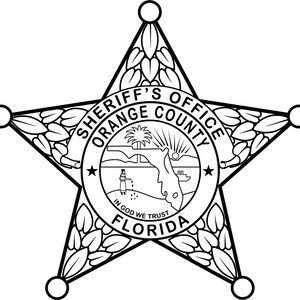 May include: Black and white Sheriff's Office badge from Orange County, Florida. The star-shaped badge features a central circular emblem with a landscape scene and the text "IN GOD WE TRUST". The badge is edged with decorative leaves.
