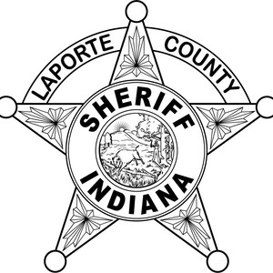 May include: Black and white illustration of a sheriff's badge with a five-pointed star. The badge says "LAPORTE COUNTY SHERIFF INDIANA" in a circle around the star.