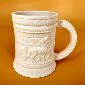 May include: White ceramic beer stein with a raised design of a chariot pulled by a horse. The stein has a handle and a detailed base.