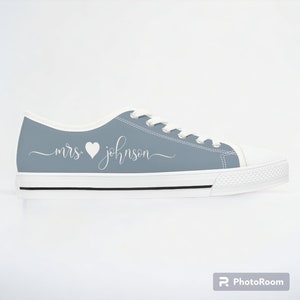 Dusty blue womens low top sneakers in a Converse style with white laces, soles, and custom text. Can be personalized with your name or text of your choice. These are ideal as bridal sneakers to match your wedding color, or your school colors.