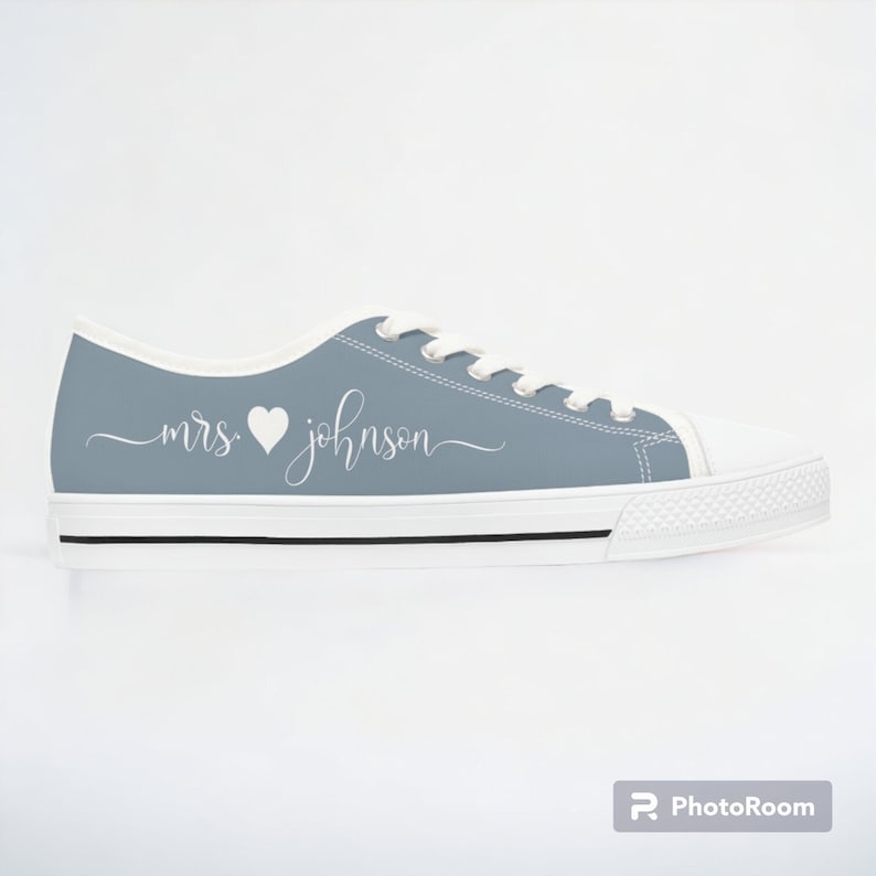 Dusty blue womens low top sneakers in a Converse style with white laces, soles, and custom text. Can be personalized with your name or text of your choice. These are ideal as bridal sneakers to match your wedding color, or your school colors.