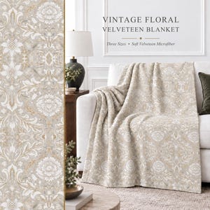 May include: A soft velveteen microfiber blanket featuring a beige and white damask floral pattern. The text on the image reads: VINTAGE FLORAL VELVETEEN BLANKET, Three Sizes, Soft Velveteen Microfiber. The blanket is draped over a white sofa.